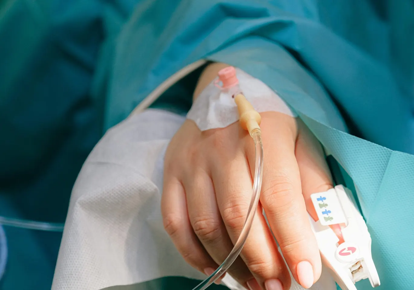 Detoks alkoholowy Tczew: dłoń z wenflonem i pulsoksymetrem pod nadzorem